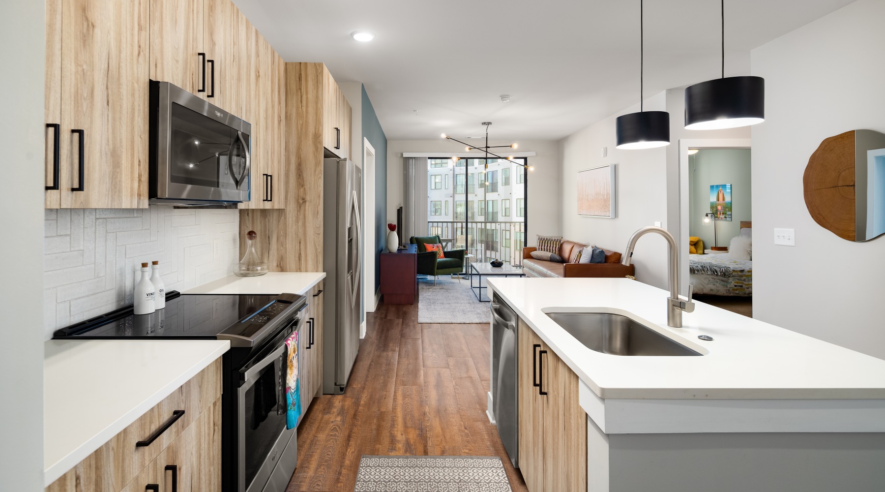 Open kitchen and living room at Annett modern apartments in Atlanta, GA. Open kitchen and living room at Annett modern apartments in Atlanta, GA.