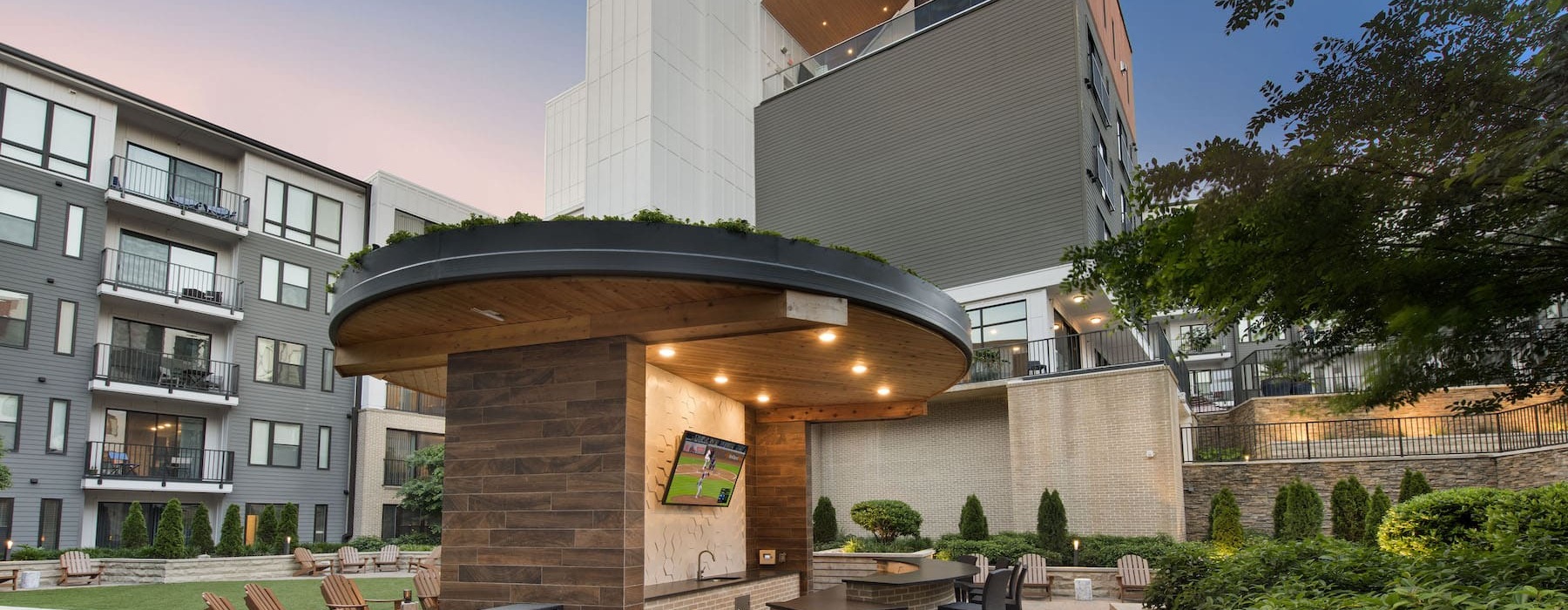 outside lounge area with bar-style seating and lush landscaping